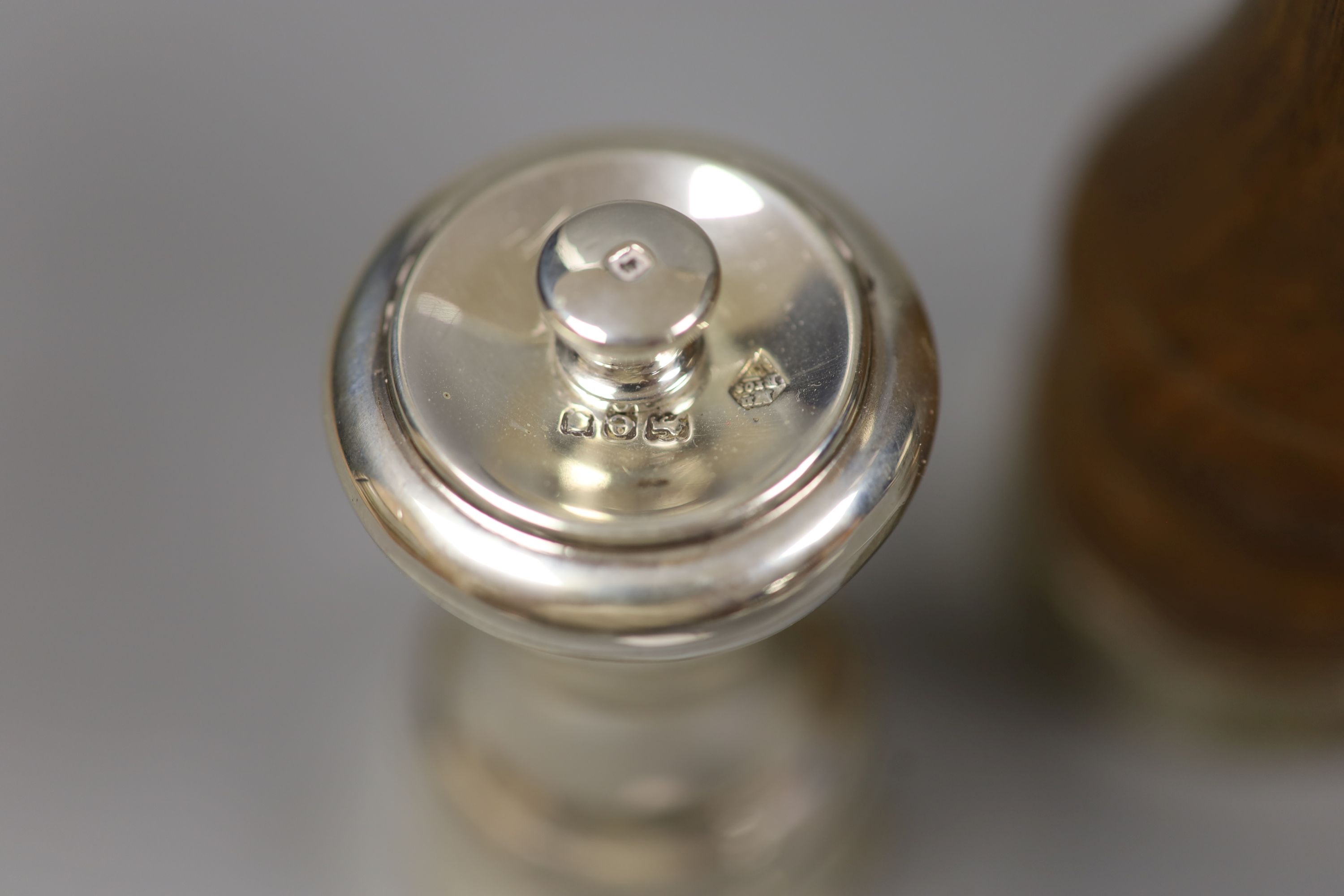 Two silver pepper mills and a silver-mounted wooden pepper mill (3)